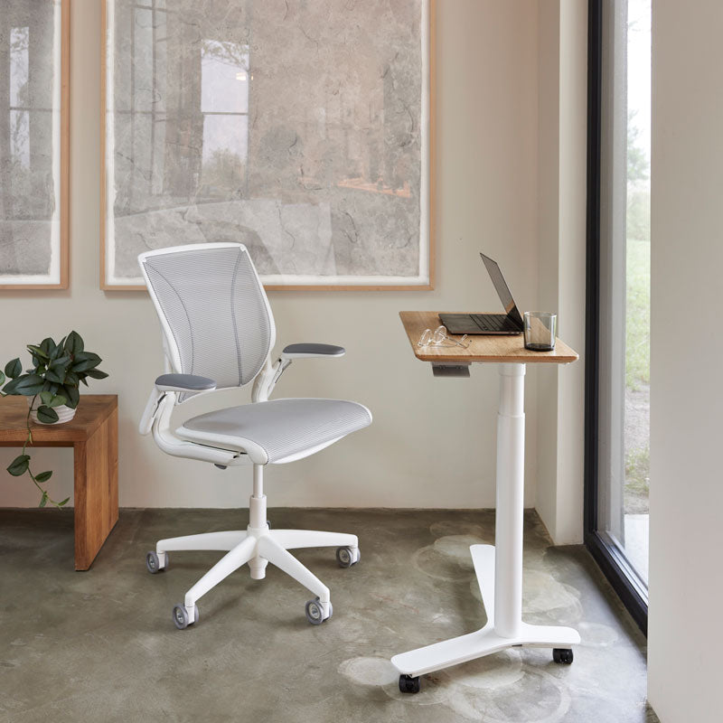 Float Mini Height Adjustable Desk. Bamboo top. White base. Black casters. Compact work surface, petite laptop table. Kansas City Office Furniture.