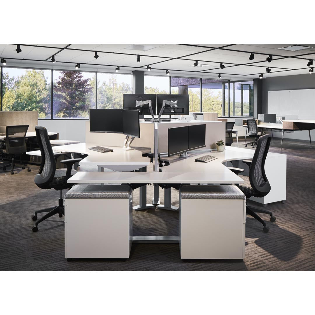 Corporate office space styled with Bolton Black Mesh Mid-Back Task Chairs, Dual Monitor Arms, height adjustable desks, naturally lit modern workspace. Kansas City office furniture. 