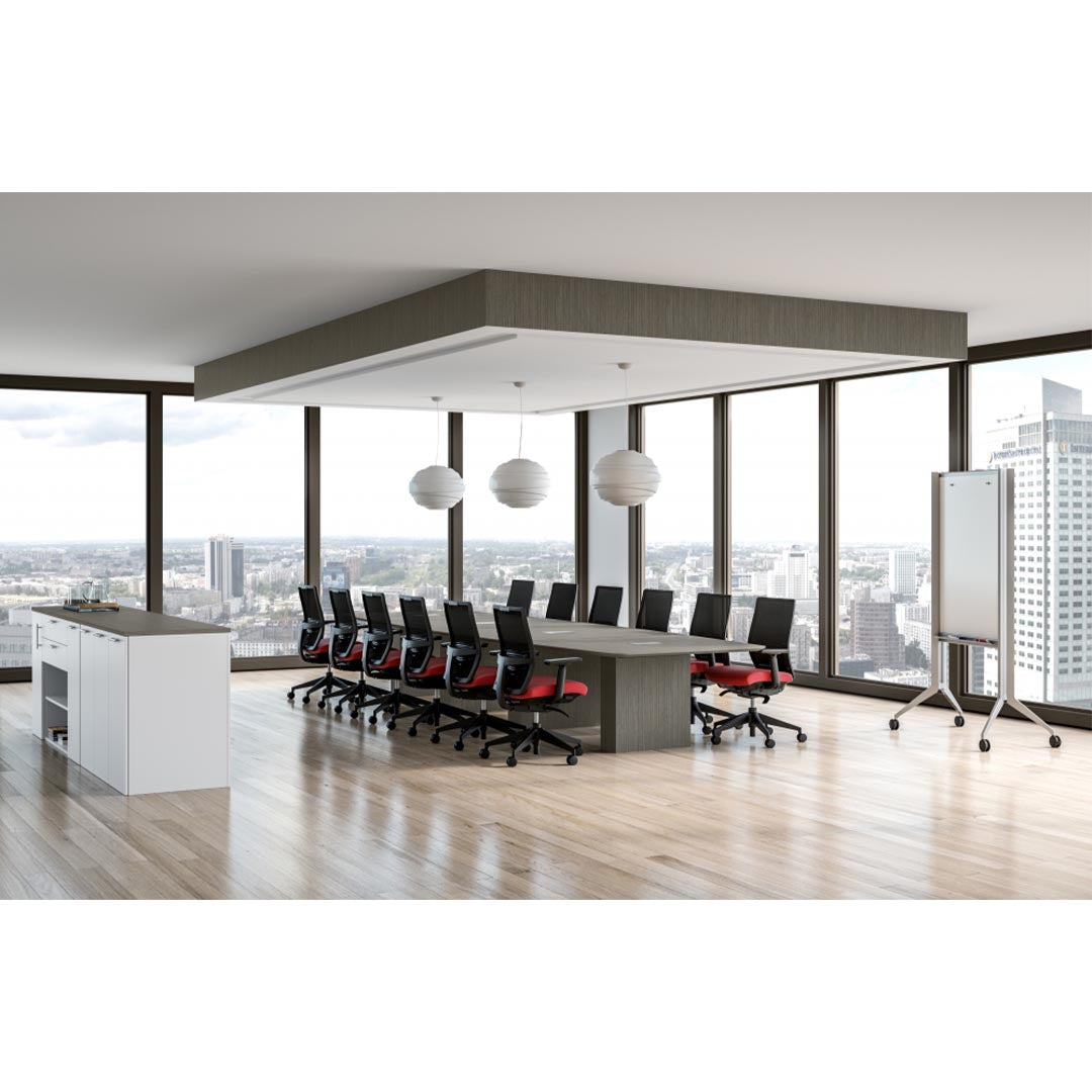 Calibrate Modern Conference Table in city view meeting room, surrounded by natural light. Boat-shaped top with knife edge. Enclosed power grommets. Kansas City Office Furniture.