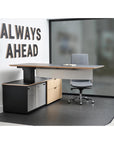 Enwork Cayman corporate office desk. Black and clear ash laminate. Height adjustable workstation positioned at standing height with modesty panel. Executive desk with lower cabinets. Kansas City office furniture