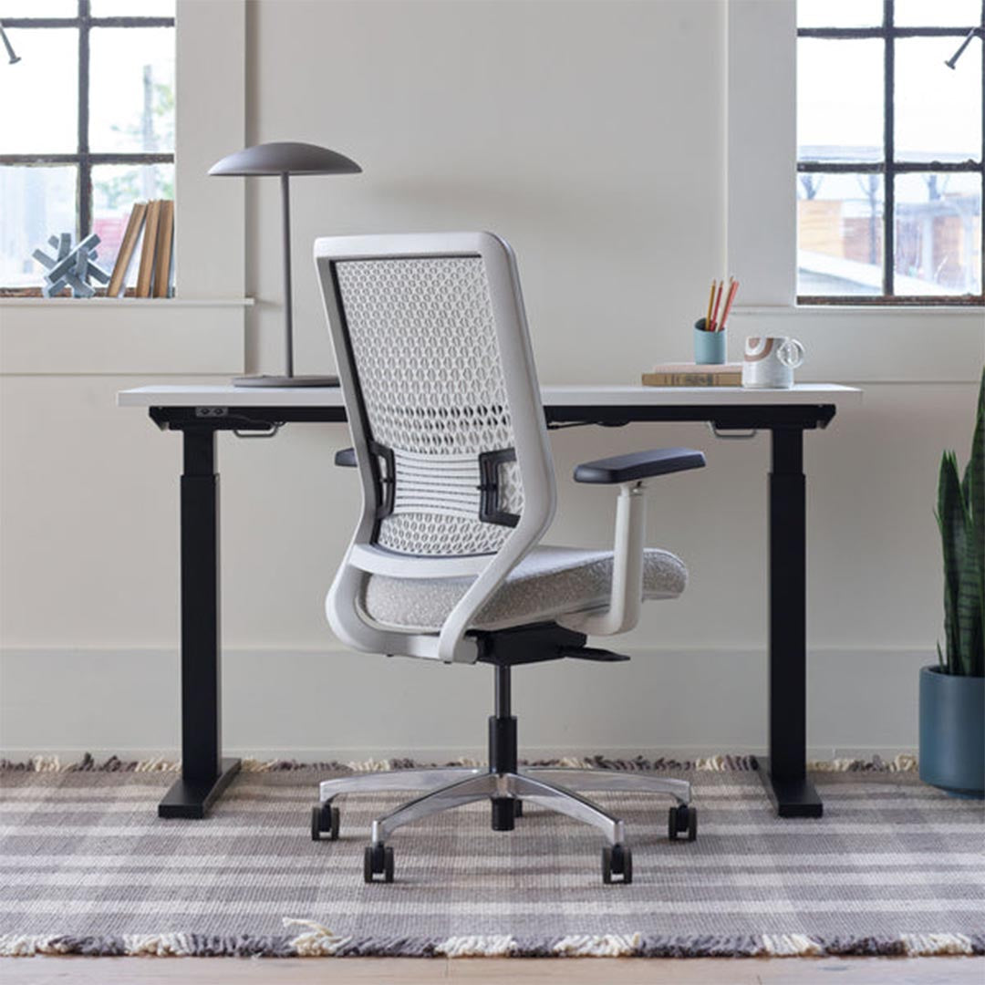 Back view of OFS Genus Office Desk Chair with Elastomer Back in cozy office with natural light, chalk frame with polished aluminum base, Kansas City Office Furniture