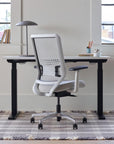 Back view of OFS Genus Office Desk Chair with Elastomer Back in cozy office with natural light, chalk frame with polished aluminum base, Kansas City Office Furniture