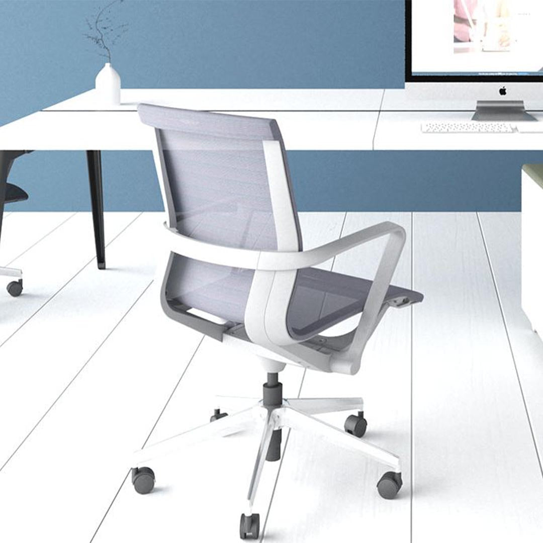 Prov Mesh Black Mid-Back Conference Chair. Back angled view at desk. Kansas City office furniture.