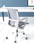 Prov Mesh Black Mid-Back Conference Chair. Back angled view at desk. Kansas City office furniture.